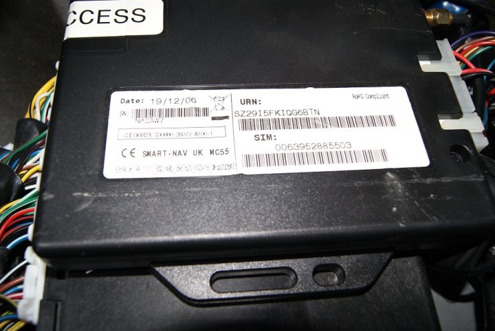 surprising find on my Scoob - Page 1 - Subaru - PistonHeads - The image captures an industrial setting involving various electrical components and settings. At the center of the frame is a black electronic device, which appears to be an electrical fuse box. Attached to it, there is a white label with barcodes and text, which is commonly used for identification and tracking purposes. The label includes information such as the part number, serial number, manufacturer's ID, and voltage and current ratings of the device. This suggests that the device is likely part of a larger electrical system, and the label is used to ensure that it can be managed effectively.