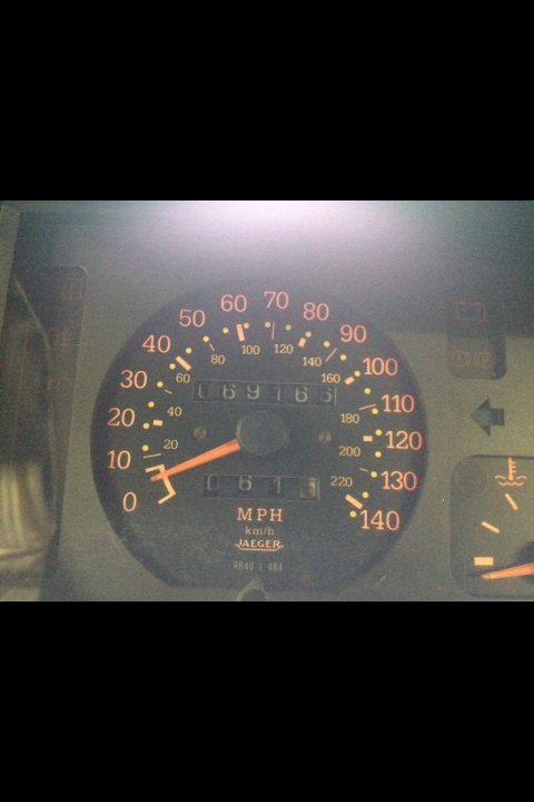 Renault 5 GT Turbo Wanted - Page 1 - French Bred - PistonHeads - The image shows a close-up of a speedometer. It's a nighttime photo, providing a dimly lit view of the display. The needle, indicating the vehicle's current speed, is set in the center of the display, which reads "MMPH" (miles per hour). The speedometer features a traditional mechanical design with red analog pointers pointing to the needle. Although the speed indicator is clearly visible, the numbers are not fully legible, but it's clear that the vehicle has accelerated quickly as there's a mix of numbers '0', '1' and '2' visible on the display.