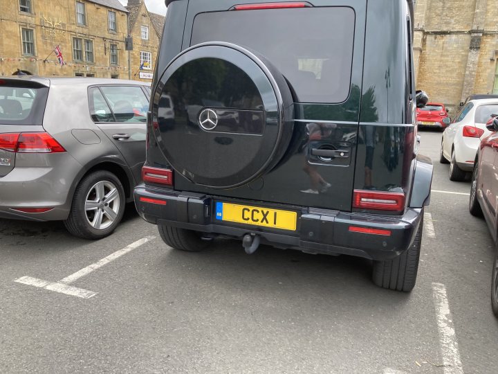 Real Good Number Plates Vol. 6 - Page 351 - General Gassing - PistonHeads UK - The image showcases a sleek, black Mercedes-Benz SUV parked in what appears to be an outdoor parking lot. The vehicle is adorned with a license plate that reads "CX1", indicating it might belong to a specific person or organization. The car's shiny exterior reflects the ambient light, adding to its luxurious appeal. In the background, there are other vehicles, suggesting this location might be a common parking area.