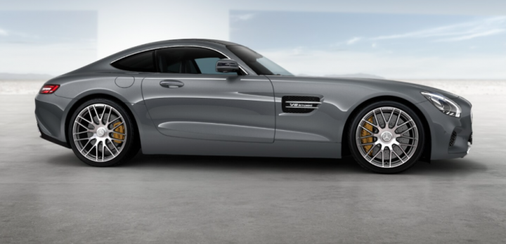 Anyone ordered an AMG GT-S yet? - Page 25 - Mercedes - PistonHeads - The image shows a sleek, gray Mercedes-Benz car from a rear three-quarter angle. The car is parked on a concrete surface, and the scene appears to be a studio setting with a clear and smooth ground surface, reinforcing the idea of a staged photograph meant to showcase the vehicle's design. A tag on the left side of the image indicates that an audio speaker is in the studio for a sound recording session. The image has a professional quality, with a focus on the vehicle's aerodynamic design, reflecting off the shiny, gray vehicle.