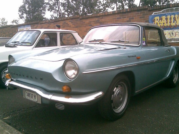 Pistonheads Renault Add - The image showcases a light green vintage car parked on the street. The car, a model year Ford Consul with a V6 engine, has a prominent curved windshield and two front headlights. In addition to these features, the car is equipped with a pair of side headlights, a grille with the Ford logo, and chrome bumpers. The car's rear view mirror reveals that another vehicle is parked behind it. The license plate on the front of the car is partially obscured, displaying only "24832 M". The image suggests a time when automobiles were simpler, with a focus on the car itself, without the clutter of modern-day objects.