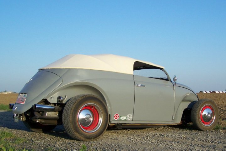 Hot Moment Liking Pistonheads Rodsi - The image showcases a vintage car parked on a gravel surface. The car's body mimics the style of a drag car, characterized by its long hood and wheelbase. The vehicle exhibits white and red color schemes, likely denoting a racing or competition theme. The car is positioned at an angle relative to the viewer, highlighting its shape and design.