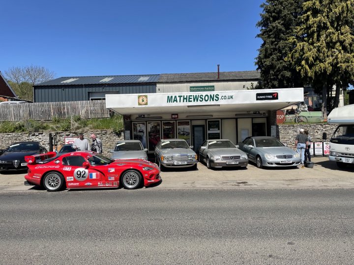 A group of cars parked in front of a building - Pistonheads