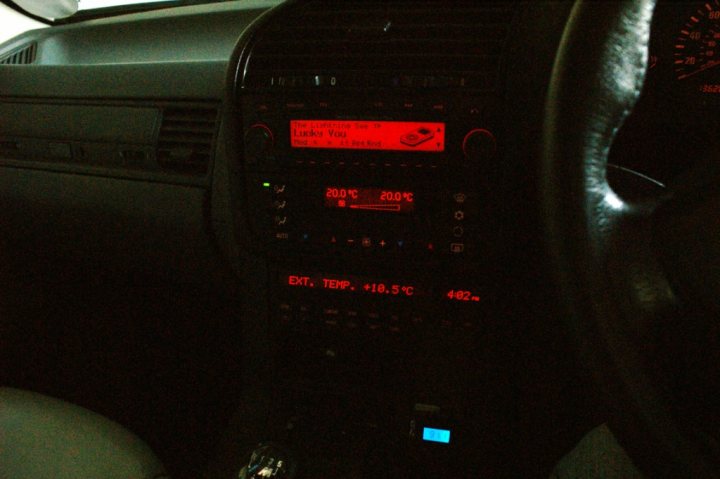 My 1997 E36 328i - Page 1 - Readers' Cars - PistonHeads - The image presents the dashboard of a car, bathed in a dim, ambient light that provides a consoling glow to the vehicle's interior. Dominating the left side of the dashboard is the navigation screen, displaying the word "LADY" in bold letters, possibly the name of a destination or a reminder from the car owner. Directly below, the temperature display indicates it's a chilly 20.C, while a traffic warning message is captured from below, suggesting the driver has a winding road ahead at 42 km/h.