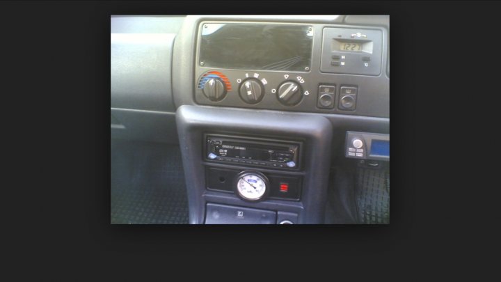 A microwave oven sitting on top of a counter - Pistonheads - The image displays an inside view of an automobile dash panel, focusing on the control panel area. The car's dashboard shows a navigation or multimedia display, and below if front, there is a stack of dials and controls. The color scheme of the vehicle's interior is predominantly black with hues of blue and silver accents. The image provides a glimpse into the vehicle's interior, specifically the cockpit, where the driver would operate the various controls and systems.