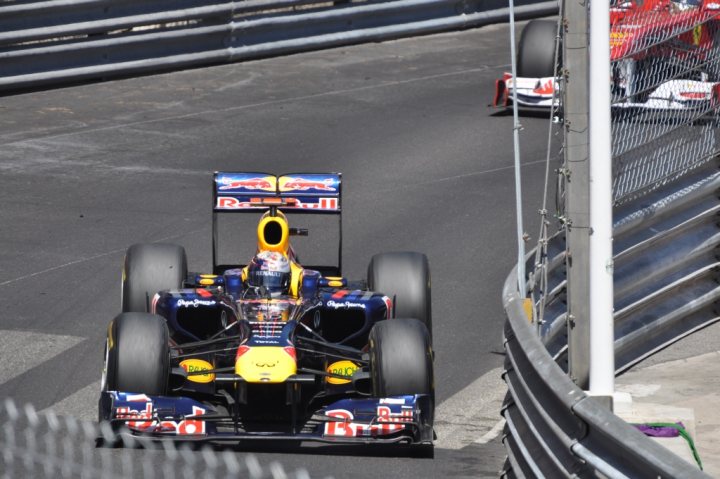 Celebrating 20 years of ... - Page 1 - Vipers - PistonHeads - The image captures a scene of high-speed racing. A striking blue and yellow Formula One car is prominently featured in the sharp curves of a race track. The car, bearing the number 3 and the logo of Red Bull, appears to be leaning into the turn, showcasing the driver's skill and the car's precise engineering. Another car can be seen in the distance, further emphasizing the competitive nature of the sport and the speed of the vehicles. The track is well-kept, with metal barriers providing safety for the drivers. The setting suggests a professional racing event, with the adrenaline of speed and the concentration of strategy being the central themes.