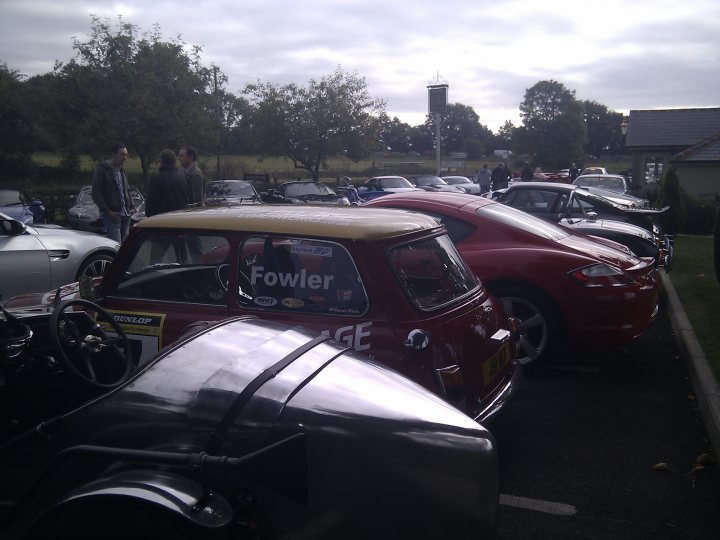 The Hare Roxwell meets ended? - Page 1 - Kent & Essex - PistonHeads - The image showcases a parking lot filled with various cars. On the left, there's a red Mini Cooper that stands out. The car is parked precisely in a designated parking space. In the foreground, numerous other cars are parked closely, creating a colorful spectacle. The overall scene suggests a car show or a gathering of automobile enthusiasts. The angle of the photo allows for a view from the driver's perspective, providing a sense of depth.