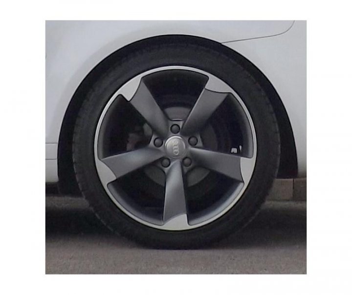 A black and white cat sitting on top of a car - Pistonheads - The image displays a close-up of a wheel from a vehicle. The wheel appears to be rugged with multiple spokes and includes the vehicle's emblem in the center. The car is predominantly white with a portion of the bumper visible. The tire shows signs of wear, indicating it may have been used for some time.