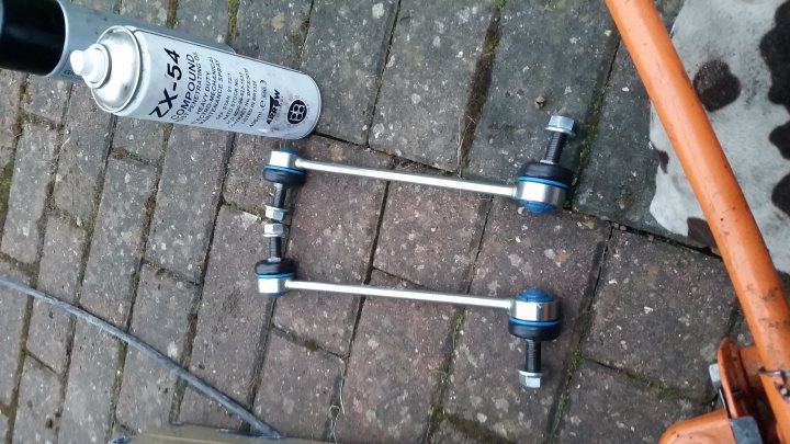 VW Transporter Day Van Conversion - Page 4 - Readers' Cars - PistonHeads - The image shows four blue and silver rattle canisters placed on a brick ground. They appear to be spray paint cans, ready for use. In the background, there's a large gray winter boot, and near it, there's a hose, partially visible. The objects suggest a potential outdoor renovation or art project. The ground is a large expanse of bricks, giving a rustic feel to the scene. The central focus is on the paint cans, highlighting them as the primary subject of the photo.