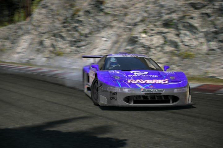 Gran Turismo 6 picture thread - Page 5 - Video Games - PistonHeads - The image shows a purple race car with white and blue accents, including the "Rimtex Group" logo, in the midst of a turn on a racetrack. The car's presence on the full-color track contrasts with the blurred, desaturated surroundings typical of a graphical representation of a race. The lower image part displays blurriness and shadows on the ground, indicating speed and movement.