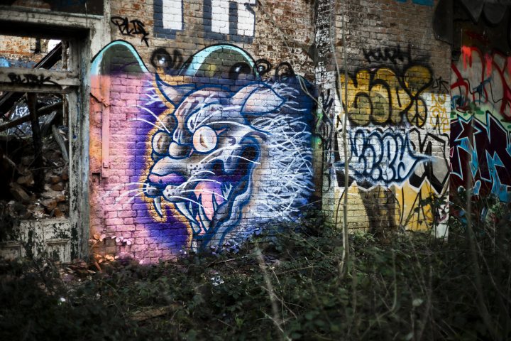 A graffiti covered wall with graffiti on it - Pistonheads