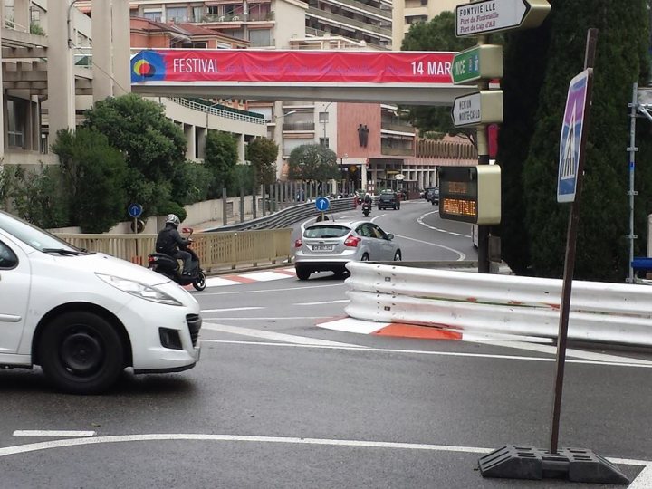 A car driving down a street next to a traffic light - Pistonheads