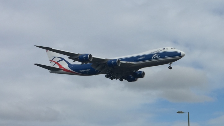 Farnborough Air Show 2016 - Page 15 - Boats, Planes & Trains - PistonHeads - The image depicts a large airplane flying towards the left side of the frame. The airplane has a striking blue and white color scheme, with the words "Compagnies" visible on its side. The aircraft also features the logo of "Compagnies des Vols du Monde" on its body, indicating that it operates internationally. The plane is positioned against a backdrop of a mostly cloudy sky. There is also a street lamp visible in the foreground, which suggests that the airplane is flying close to a populated area.