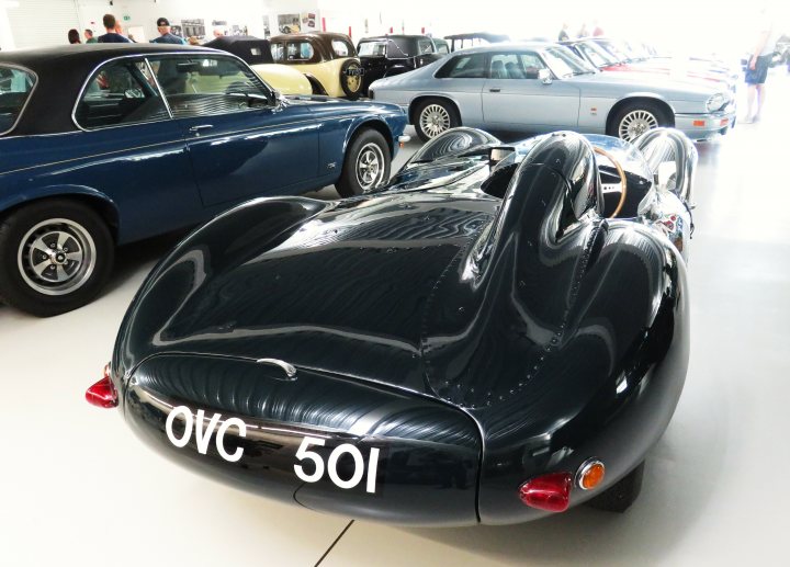 Pistonheads - The image shows a vintage sports car on display in an indoor setting, likely a museum or exhibition space. The vehicle is black with chrome accents and has a sleek design typical of classic race cars. In the background, several other vintage cars can be seen, suggesting this might be a collection or special event showcasing classic automobiles. There are people present in the scene, indicating that it's open to visitors, and they appear to be engaged with the exhibits.