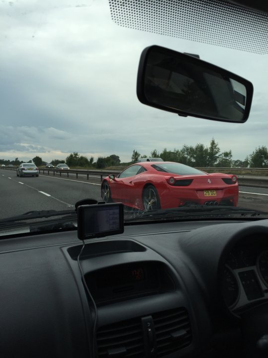 Real Good Number Plates : Vol 4 - Page 383 - General Gassing - PistonHeads - The image captures a moment on a highway where three cars are visible. The most striking feature is a red sports car driving away from the camera's viewpoint. The car has a distinctive license plate that reads "U3 YE". The perspective of the image is from the interior of a car, specifically from the passenger seat. The dashboard of the vehicle is in view, and the rearview mirror shows a reflection of the highway with the sports car in it. Although the highway has multiple lanes and stretches into the distance, it appears to be clear and free of traffic, except for the cars already visible.