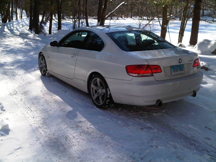 What do you drive? - Page 1 - USA & Canada - PistonHeads - The image shows a white BMW car parked on a snow-covered ground surrounded by trees. The car is situated on a path that is also covered in snow and is oriented towards the left side of the photo. The license plate of the car reads "3V8106". The environment suggests a wintery, possibly rural setting.