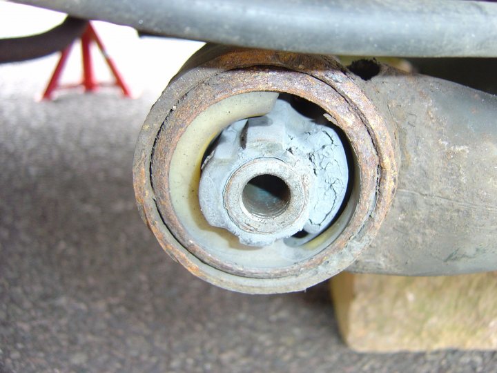 Pistonheads - The image shows a close-up view of a rusty metal disk, likely a part of a car or a vehicle. The disk is evidently worn and rusted, suggesting it's either been in use for an extensive period or hasn't been maintained properly. Inside the disk, there appears to be a circular cylinder-like object, which might be the hinge or a component of the air suspension system. The simplistic composition of the image emphasizes the textures and the decaying state of the metal. The image might be related to mechanics, rust prevention, or vehicle preservation. There's no superimposed text or any action happening in the image. The dominant colors in the scene are shades of gray, orange, and blue due to the rust and reflection of the surrounding environment.