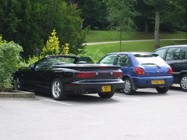 A car parked in a parking lot next to a car - Pistonheads