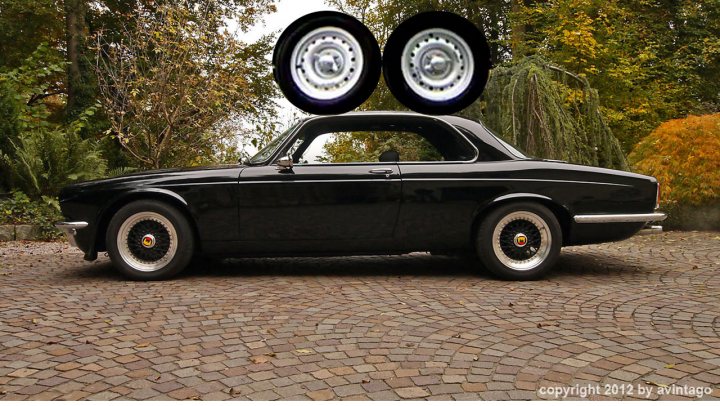 Photoshop help needed - Page 1 - General Gassing - PistonHeads - The image shows a classic, black car parked on a cobblestone street. The car has a shiny finish and features two prominent hub caps. Positioned over the car is a sizable circular object that resembles a tire with white walls and false spokes, creating a humorous and exaggerated illusion that the car is supported by two parallel hub caps. The setting appears to be a peaceful residential area, with trees and lush greenery in the background, casting a serene and picturesque ambiance for the vintage vehicle.