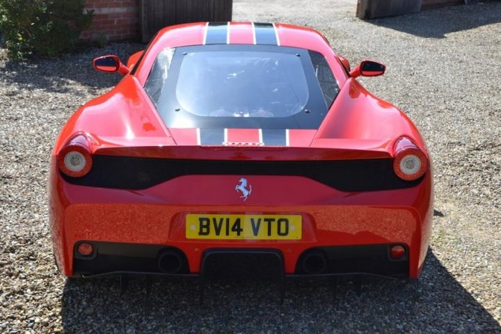 458 Speciale - Page 1 - East Anglia - PistonHeads - The image showcases a vibrant red Ferrari, distinguished by its sharp lines and iconic badge on the rear. The Ferrari is parked on a gravel driveway, offering a contrast to its sleek design. The license plate reads "BV14 VTO", hinting at the car's origin or affiliation. The perspective of the photo is slightly above the car, looking down on the vehicle, which emphasizes its prominence and luxury appeal.