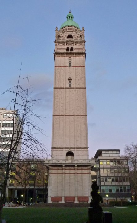 Where was I? - Page 273 - Holidays & Travel - PistonHeads - This image captures a tall, imposing tower made of concrete. The tower is large and rectangular, reminiscent of a clock tower or a tall building. The photo is taken from a low angle, which gives a grand perspective of the tower against the sky. The sky is clear and devoid of clouds, implying fair weather conditions. There is no visible text or branding in the image.