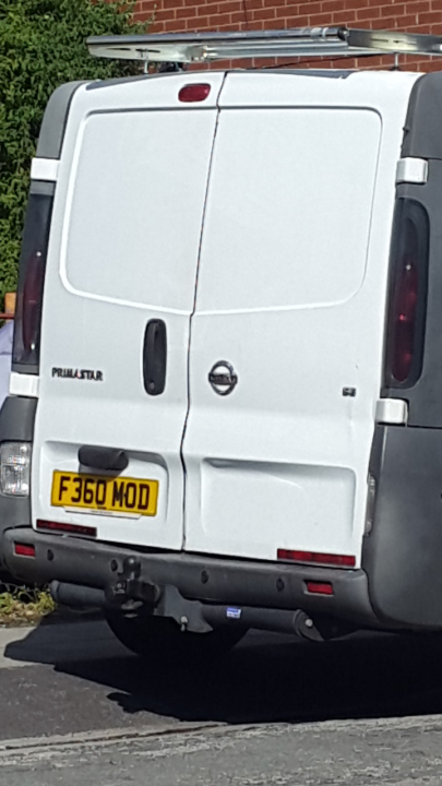 F360 Modena anyone? - Page 1 - Ferrari V8 - PistonHeads - This image features a white cargo van parked on a street. The van's license plate reads "F360 MOD." It appears to have a black rubber bumper, and there is a spare tire mounted on the back. In the background, there is a brick building or wall. The lighting suggests it may be daytime. The van appears to be relatively recent as indicated by its design and condition.