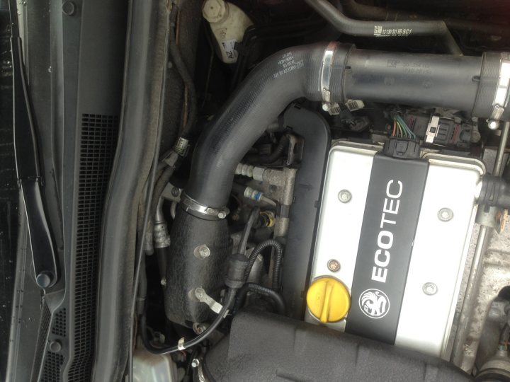 Anyone know there way around a Z20LEL Engine, Help required? - Page 1 - VX - PistonHeads - The image showcases a close-up view of a car engine with various metal components painted black, possibly to reduce heat retention. On the side, there's a distinct yellow button, which could be a safety or warning feature. The engine is also equipped with a black plastic casing labeled "ECOTEC," suggesting it's part of an eco-friendly feature. Regardless of the specific makes or models, this image gives a glimpse into the intricate complexities of a car's inner workings.