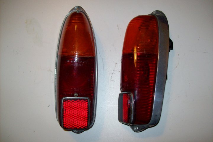 Pistonheads Lights Italian Identify Classic - The image displays two illuminated taillights mounted on a white surface. Each taillight is compact, featuring a silver casing that houses the illuminated bulbs. They have a red, luminous backlight. The bulbs are encased into the top portion of each taillight. Due to their small size and the limited context provided by the image, it's challenging to determine their specific function or the context in which they're placed.