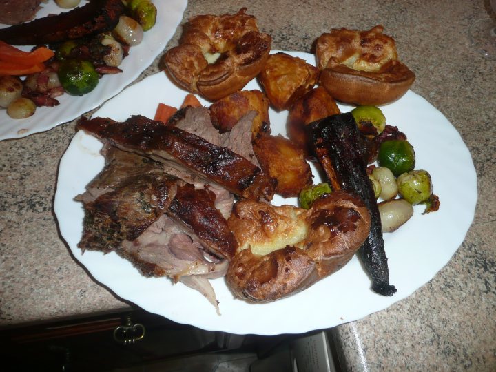 Pistonheads - The image shows a meal served on a plate, placed on a granite countertop. The plate contains a variety of food items including what appears to be roast beef, roasted potatoes, carrots, and Brussels sprouts, suggesting a well-balanced and hearty meal. Additionally, there's a round pastry with a dark brown top, possibly a puff pastry or similar pastry, creating a contrast of colors on the plate. The arrangement of the food on the plate completes a picturesque presentation, highlighting each food item and adding to the overall appeal of the meal.