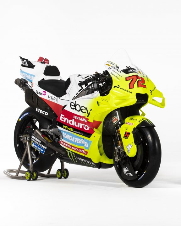 Pistonheads - The image depicts a motorcycle that is part of a racing team. The motorcycle has a bright yellow color scheme, which is typical for racing bikes to increase visibility on the track. It features the number 70, suggesting it's used by or sponsored by rider #70. There are various sponsor logos and branding visible on the bike, including what appears to be a betting company and other sports-related brands. The motorcycle is parked indoors on a stand, likely in a garage or exhibition space. The background is plain white, focusing attention on the motorcycle itself.