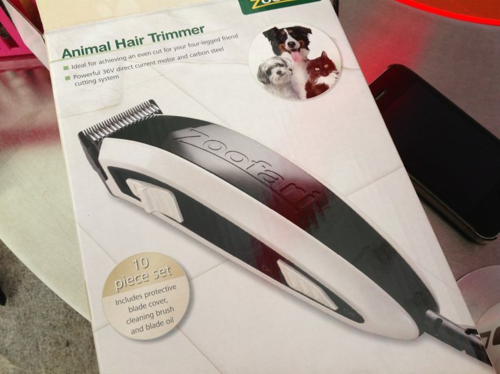 Home Clipping  A Terrier - Page 1 - All Creatures Great & Small - PistonHeads - The image displays a product, specifically an electric hair trimmer with a reusable blade cartridge. A circular sticker is affixed to the packaging, featuring pictures of small dogs. The box is predominantly white with a black area on the right side, and there's text mentioning the brand "Animal Hair Trimmer."