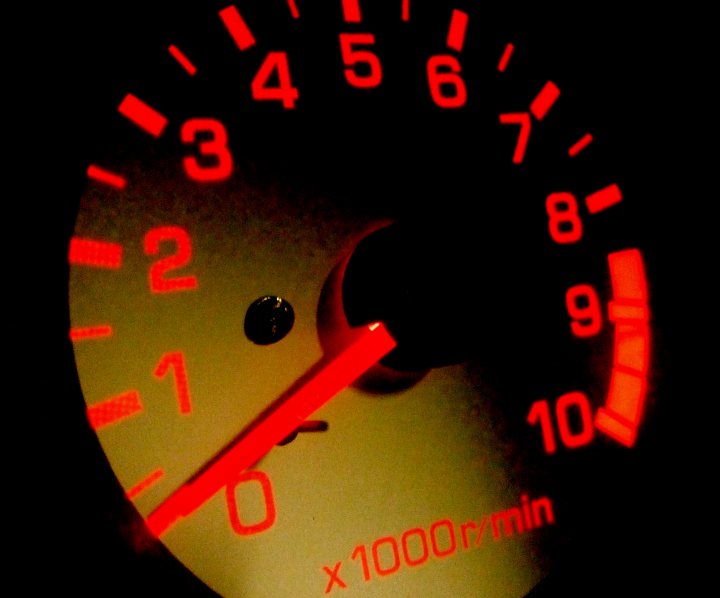 Pistonheads Avanzato Cuore Daihatsu - The image shows a close up of an analog speedometer from a vehicle. The speedometer needle is positioned at the number '3'. There is text that includes the words "100m/in" on the indicator, indicating the measurement unit used. The gauge itself has a circular layout with numbers ranging from '0' to '120', representing higher speeds. The indicator is illuminated in red, which is typical for fuel level indicators on vehicles' dashboards.