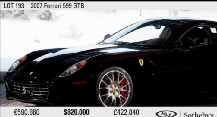 Manual Ferrari 599 at auction - Page 1 - Ferrari V12 - PistonHeads - The image features a stunning black Ferrari 599 GTB captured from a rear, three-quarter perspective, licence plate visible. The car is parked on a brick surface, angled away from the camera, presenting the left side and the rear, offering a full view of the vehicle without any obstructions. The brilliant light reflects off the glossy Ferrari, highlighting its sleek design and the shiny rims. The background is out of focus, emphasizing the lacquerlike black finish of the car.