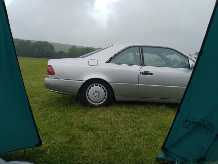 A white car is parked in a field - Pistonheads