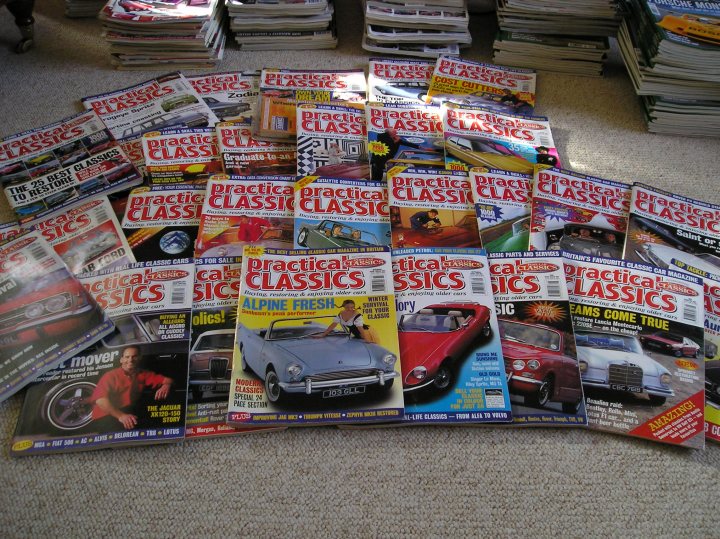 free to a good home [see pics] - Page 1 - Classic Cars and Yesterday's Heroes - PistonHeads - This image captures a collection of "Practical Classics" magazines spread out on a beige carpeted floor. There are at least ten magazines in total, suggesting different issues of the publication. Each magazine is colorful with various images and text on the cover, offering a glimpse into the automotive content within. The magazines range in orientation from portrait to landscape, suggesting a variety of layouts. Their arrangement on the floor gives a sense of informality, perhaps indicating they are in the process of being organized or sorted through.