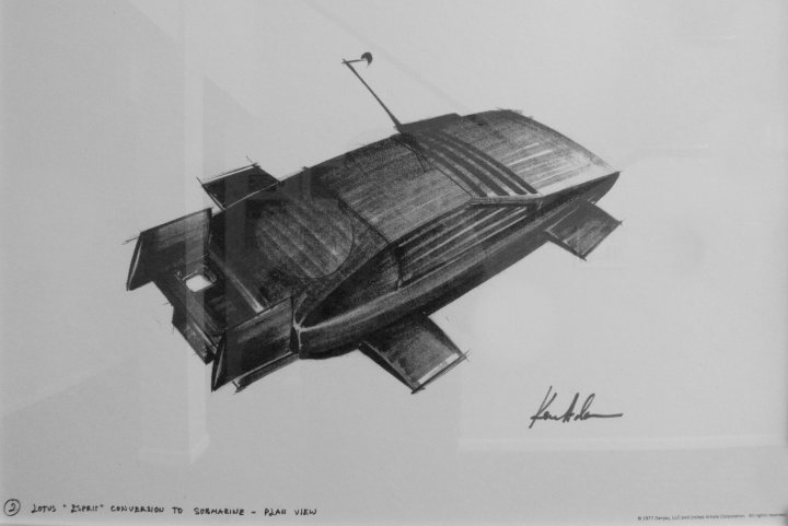 Pinewood Pistonheads Studios - This image features a captivating black and white sketch of a UFO, or unidentified flying object. The UFO, which appears to be floating in the air, is the central object in the image. The artist's skillful use of black and white contrasts the darker body of the UFO against a lighter background, effectively drawing the viewer's attention to the extraterrestrial craft. The genre of the artwork is science fiction, a popular form of art and storytelling. The artist's signature, "K.H.K." located at the bottom right of the image, suggests a personal connection to the artwork, perhaps indicating the identity of the creator.