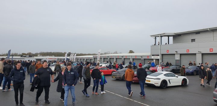 A group of people standing in front of a bus - Pistonheads