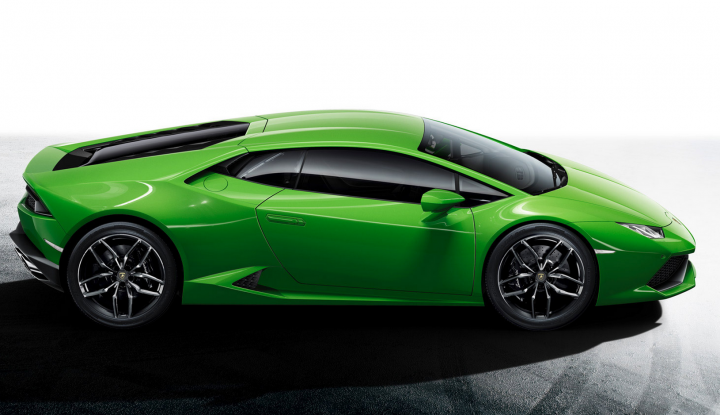 Lamborghini Huracan: OFFICIALLY REVEALED - Page 1 - Gallardo/Huracan - PistonHeads - The image showcases a striking green sports car positioned sideways, giving a clear view of its striking design. The sleek vehicle is set against a stark white background, which accentuates its vibrant color. The car is parked in a dynamic manner, with the rear wheel turned slightly towards the viewer, suggesting movement and speed. The dashboard, visible through the windows, adds a detail to the composition, hinting at the car's interior and the driver's perspective.