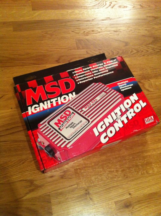 A stack of books sitting on top of a table - Pistonheads - The image showcases a user manual for an MSD Ignition Control (MSD I/C). The manual is resting on a wooden surface, placed upright for viewing. It is characterized by its vibrant red and black color scheme, with a prominent image of the MSD I/C device on the cover. The title "MSD IGNITION CONTROL" is boldly printed on the cover, signaling its function and intended audience. The manual likely provides detailed instructions and information about the performance and functionality of the MSD IGNITION CONTROL, aiding users in getting the most out of the device.