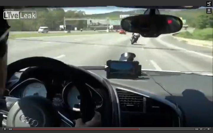 Really fast cars v bikes? - Page 7 - General Gassing - PistonHeads - The image appears to be a screenshot from a vehicle dashboard, seemingly from a car or motorcycle. The dashboard displays various gauges and controls typical of a vehicle interior. The vehicle is driving on a road with other vehicles visible in the background of the image. A partially visible motorcycle is passing by the camera's perspective, and there is text on the image that reads "LiveLeak," suggesting the image may have been recorded from a live streaming video platform.