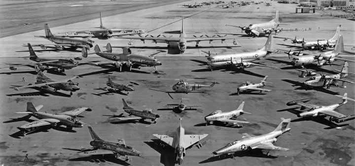 Post amazingly cool pictures of aircraft (Volume 2) - Page 314 - Boats, Planes & Trains - PistonHeads - The image is a black and white photograph showing a tarmac or airfield with various types of aircraft. The aircraft differ in size, shape, and design, indicating a diverse collection. Some of the planes are parked side by side, while others are scattered or facing different directions. The layout suggests a display or collection of vintage or historic aircraft. There are no visible people or brands, reinforcing the historical or possibly commemorative nature of the image.