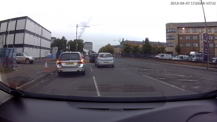 A car driving down a street next to a traffic light - Pistonheads
