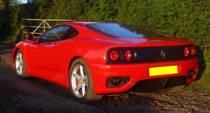 A red car with a surfboard on top of it - Pistonheads