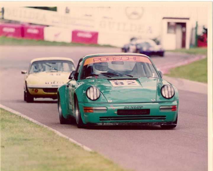 my porsche's - Page 1 - Readers' Cars - PistonHeads - The image captures an exciting scene of car racing on a track. In the foreground, a distinctive green Porsche race car is the main focus. It displays the number 82 and the word "Dunlop," suggesting its sponsor. The Porsche car is in full racing gear, with a front license plate and headlights, indicating it's ready to compete. 

In the background, two other cars are visible on the same track. The image has a vintage feel to it, as if it's an old photo, capturing a moment from a bygone era of racing. The cars are placed in a dynamic arrangement, implying motion and speed. It's a snapshot of a thrilling car race, with the Porsche car poised in anticipation of the others.