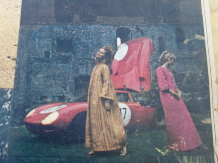 Pistonheads Website Classic - The image captures a surreal scene where two women, one blonde and one brunette, are standing beside a vibrant red car that is parked in an open area. The car itself is striking, with the hood propped up revealing a shiny engine. The car's position in the center of the image draws attention, contrasting with the muted colors of the background. The setting suggests a peaceful environment, with a wall of textures subtly visible behind the car. The image's vibrancy and contrast highlight the unusual activity of the car's hood being propped up, adding an element of intrigue to the scene.