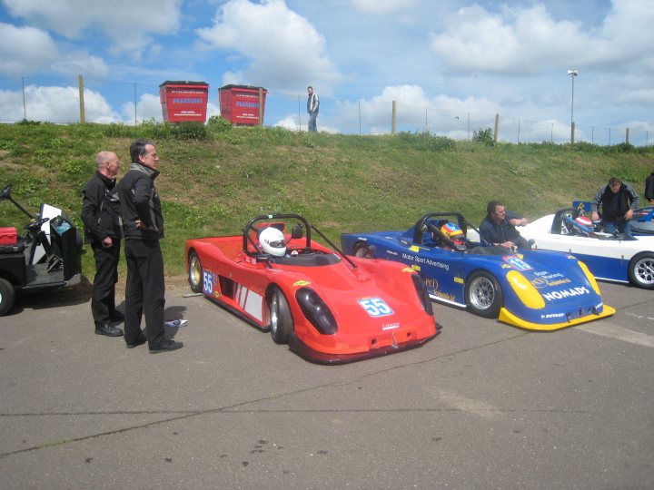 A group of people standing next to a motorcycle - Pistonheads