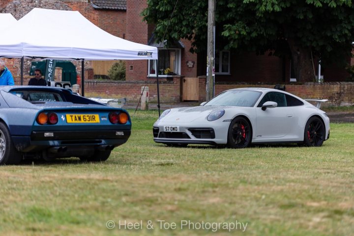 A car is parked on the grass next to a car - Pistonheads