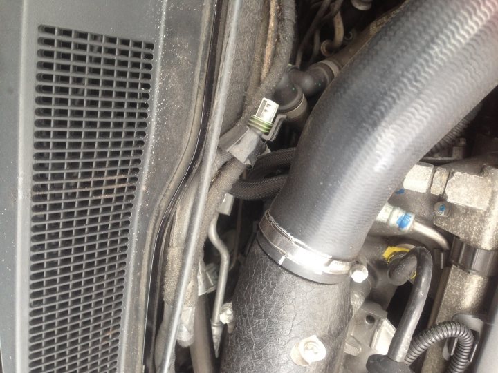 Anyone know there way around a Z20LEL Engine, Help required? - Page 1 - VX - PistonHeads - The image shows a close-up view of the engine compartment of a vehicle. There is a prominent rubber air cleaner visible on the left side of the photo. A shiny metal tube, possibly aluminum or steel, stretches across the frame, which is part of the vehicle's mechanical components. Moving towards the center and right side of the photo, several other metal components and hoses are visible. The image is taken from an angle that allows the viewer to look deep into the structural layers of the vehicle.