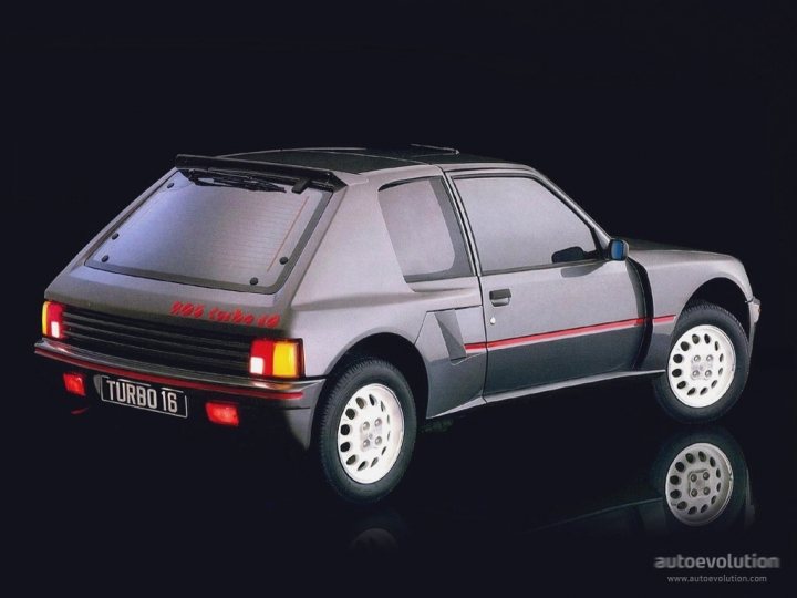 My Peugeot 205gti (Dimma) Restoration - Page 9 - Readers' Cars - PistonHeads - The image features a digital rendering of a compact car. The car is predominantly silver with accents in black and gray. It has a sporty design, with a sloping rear roofline and a pronounced front wheel arch. The vehicle is equipped with a rear license plate, a sunroof, and body-colored wheels shod with circular patterns and eight visible lug nuts. The license plate reads "TURBO 18." The display reflects the car's underside and wheels, adding depth to the image. The overall style of the car suggests a fusion of classic and contemporary design elements common in high-performance compacts.