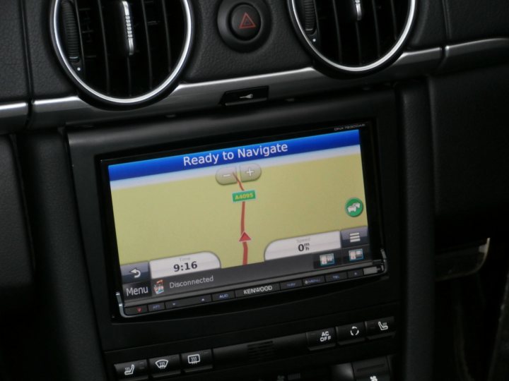 Cayman 997.2 Radio Options - Page 1 - Boxster/Cayman - PistonHeads - The image shows the interior view of a vehicle's instrument panel displaying a Navigational system screen. The screen shows a direction indicator, indicating a right turn, with "9:16 Disconnected" at the top. A yellow route map is displayed with a highlighted right turn lane. The scene appears to be taken during a right turn, and the vehicle appears to be stationary.